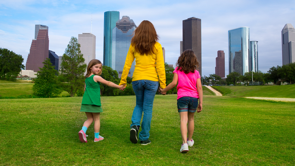 mother and daughters walking in Houston park
